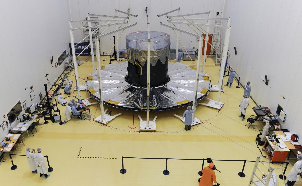 Cylindrical Gaia satellite under preparation by clean-suited scientists